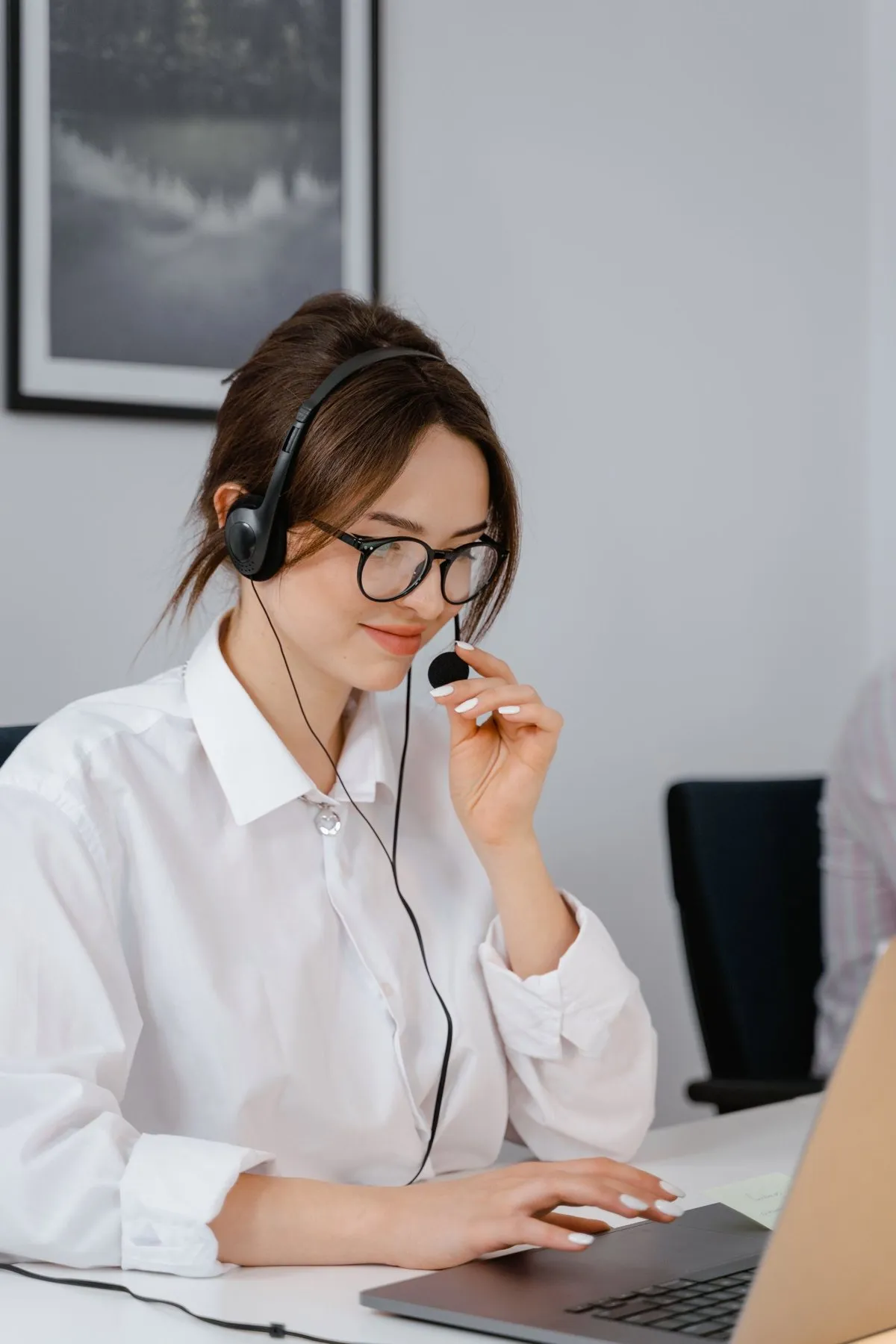 Specialist with a headset working on a laptop