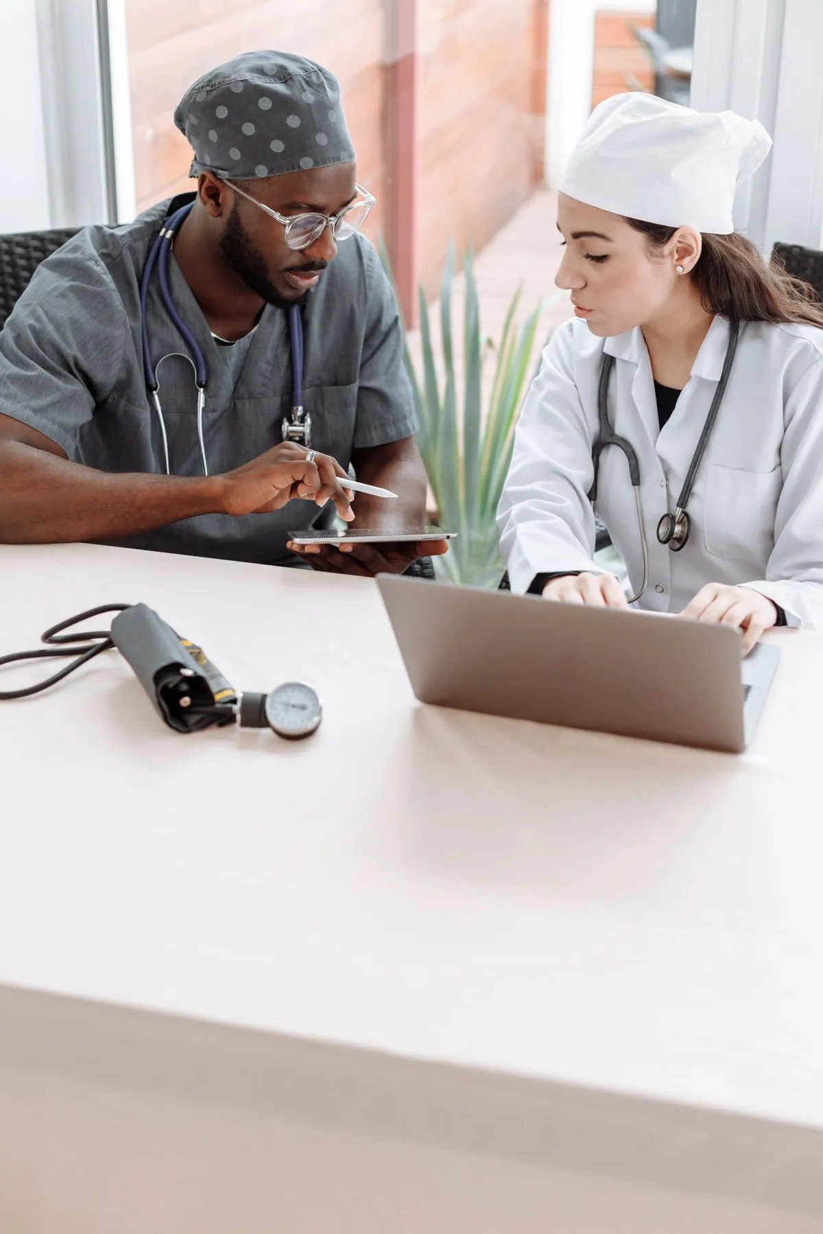 Two healthcare professionals reviewing a tablet together